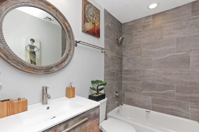 a bedroom with a bed and a lamp on the table