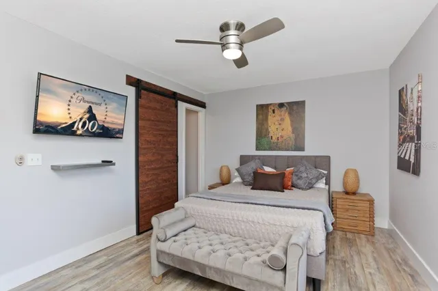 a view of a hallway with wooden floor and a white wall