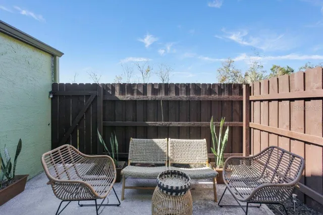 a view of a house with swimming pool and sitting area