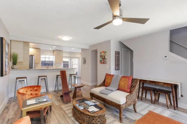 a living room with furniture and a dining table