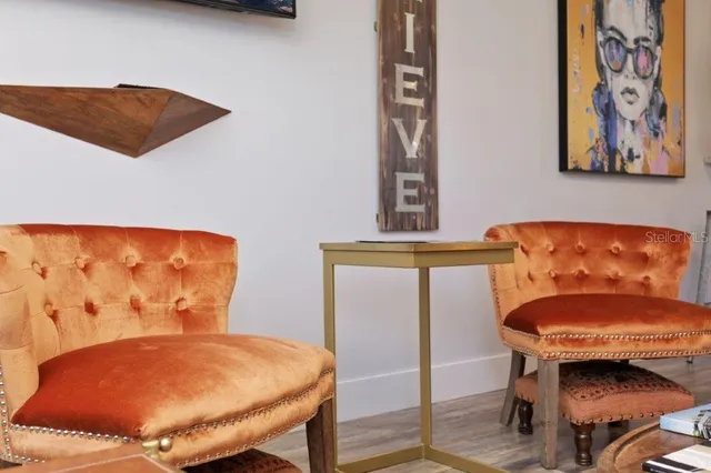 a blue chair sitting in a kitchen next to a window