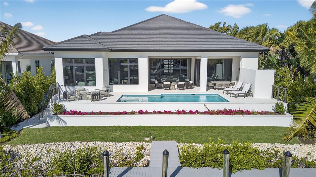 a front view of a house with a garden and sitting area