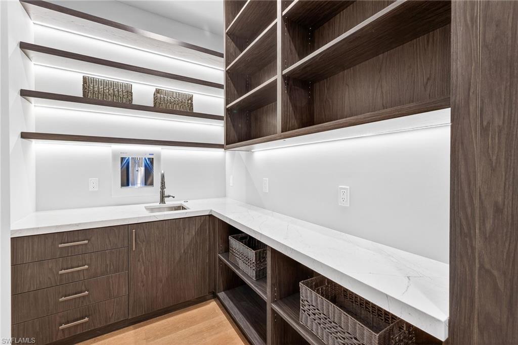 1456 Curlew Avenue Naples, FL 34102 - Photo 13 of 35 a kitchen with a sink and cabinets