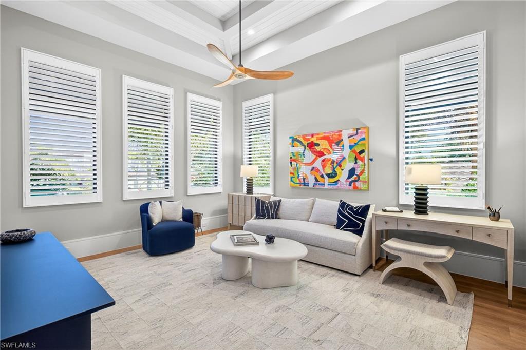 1456 Curlew Avenue Naples, FL 34102 - Photo 16 of 35 a living room with furniture a flat screen tv and a window