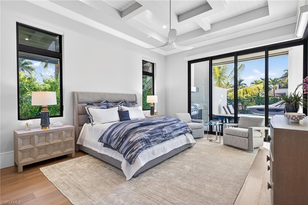 1456 Curlew Avenue Naples, FL 34102 - Photo 17 of 35 a spacious bedroom with a large bed and a large window