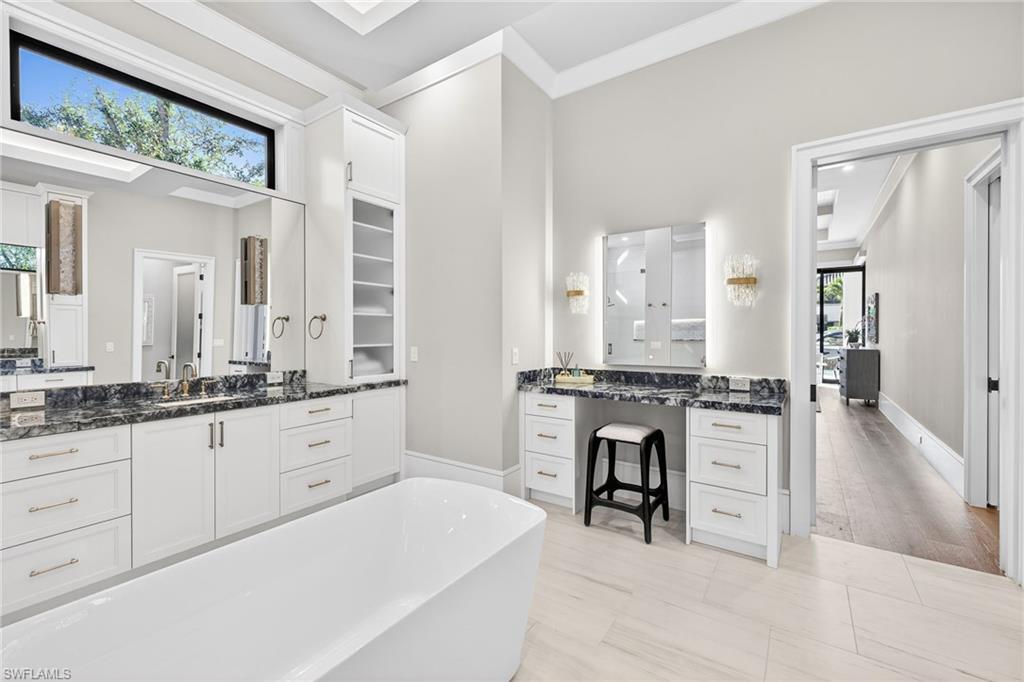 1456 Curlew Avenue Naples, FL 34102 - Photo 20 of 35 a large white bathroom with a granite countertop sink and a mirror