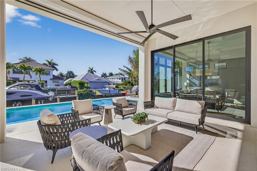 1456 Curlew Avenue Naples, FL 34102 - Photo 23 of 35 a outdoor living space with furniture and garden view