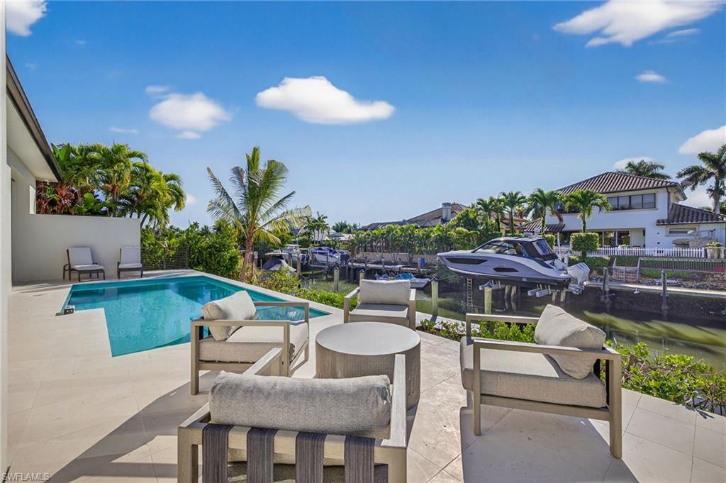 1456 Curlew Avenue Naples, FL 34102 - Photo 3 of 35 a view of a swimming pool with outdoor seating space