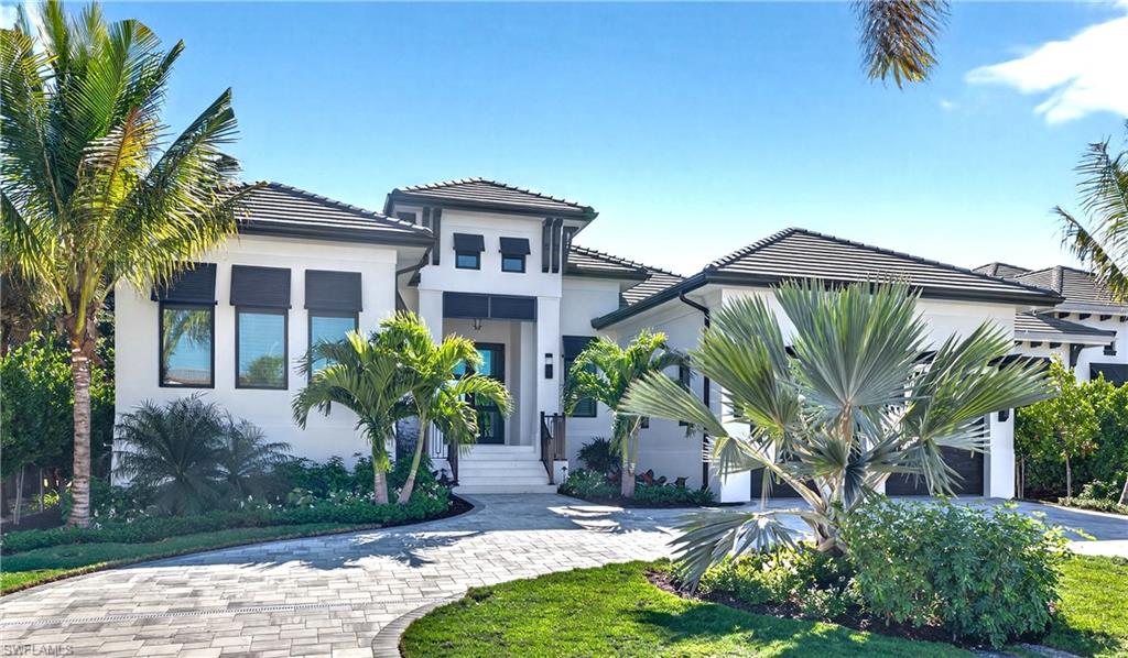1456 Curlew Avenue Naples, FL 34102 - Photo 5 of 35 a front view of a house with garden