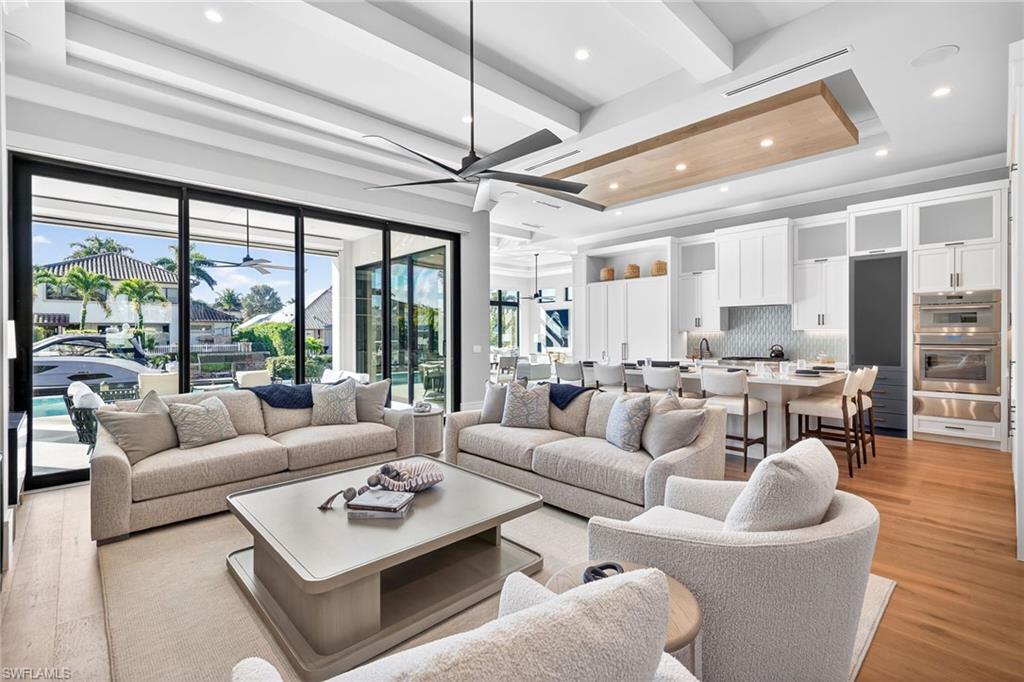 1456 Curlew Avenue Naples, FL 34102 - Photo 7 of 35 a living room with furniture and a large window with wooden floor