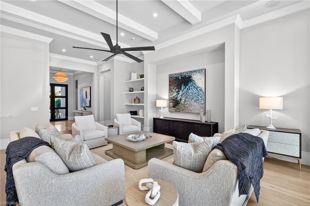 1456 Curlew Avenue Naples, FL 34102 - Photo 8 of 35 a living room with furniture a chandelier and a rug