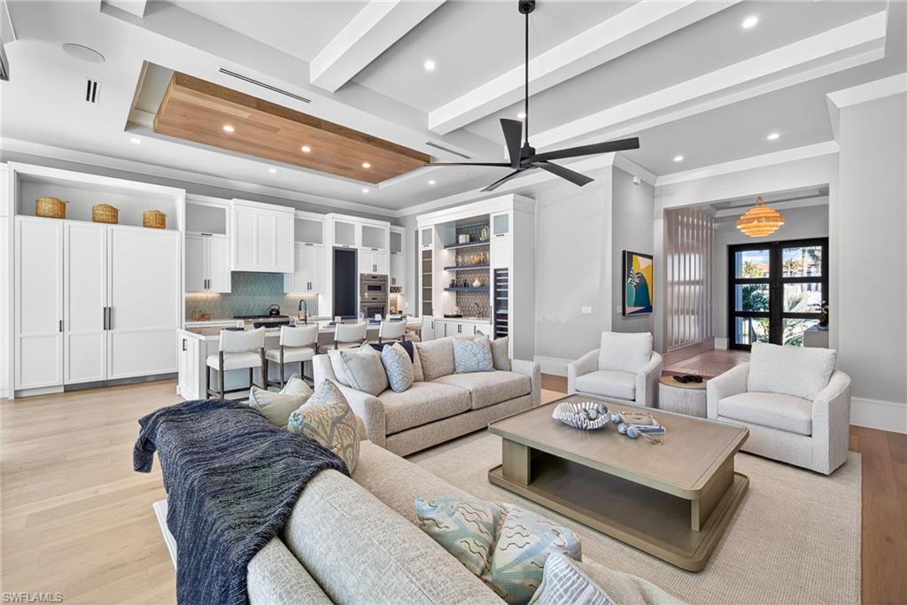 1456 Curlew Avenue Naples, FL 34102 - Photo 9 of 35 a living room with furniture kitchen view and a chandelier