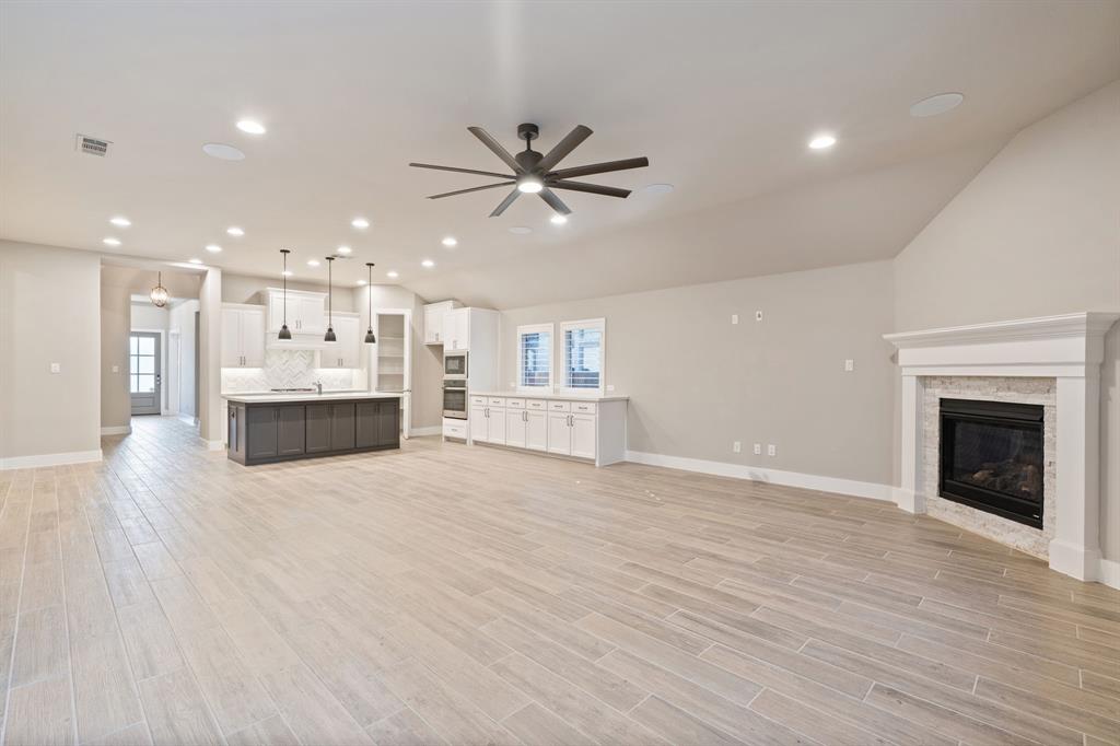 1314 Buttermere Street Forney, TX 75126 - Photo 5 of 32 a view of a kitchen with a sink and a fireplace