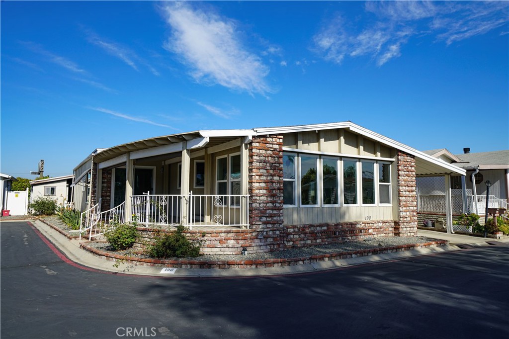 1919 West Coronet Avenue, Unit 190 Anaheim, CA 92801 - Photo 1 of 31 a front view of a house with yard and green space