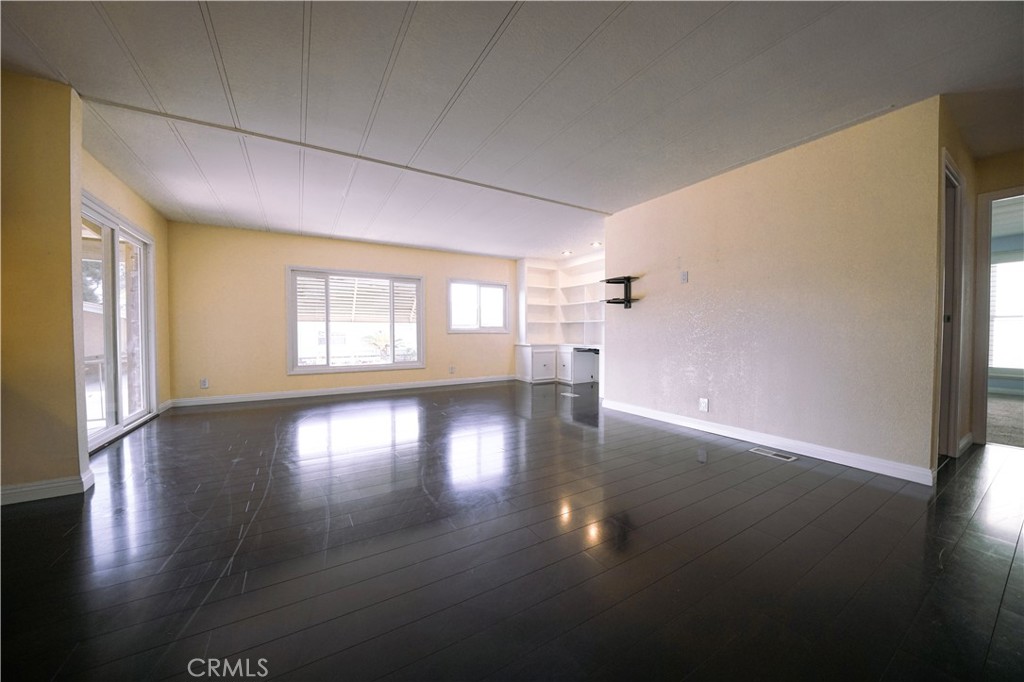 1919 West Coronet Avenue, Unit 190 Anaheim, CA 92801 - Photo 11 of 31 wooden floor in an empty room with a window