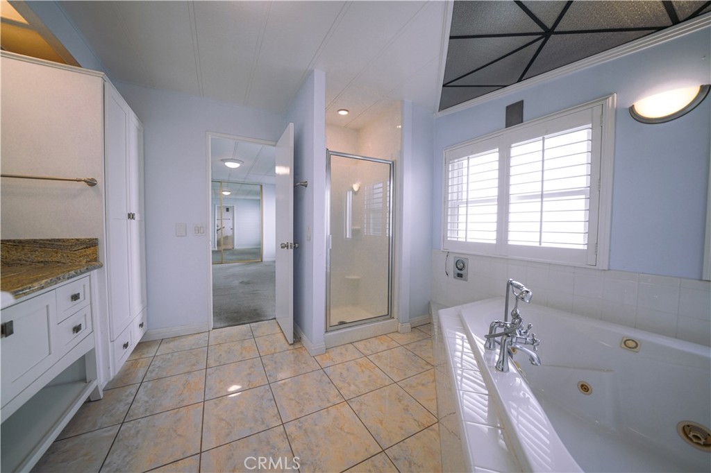 1919 West Coronet Avenue, Unit 190 Anaheim, CA 92801 - Photo 15 of 31 a bathroom with a bathtub and a shower