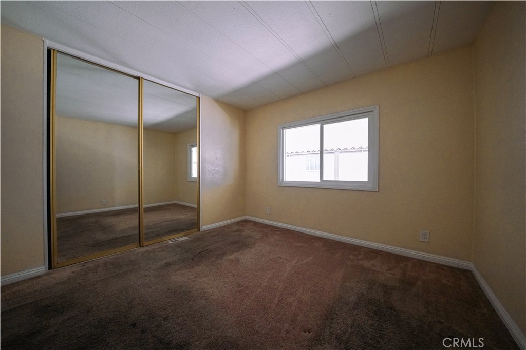 1919 West Coronet Avenue, Unit 190 Anaheim, CA 92801 - Photo 16 of 31 an empty room with windows and closet