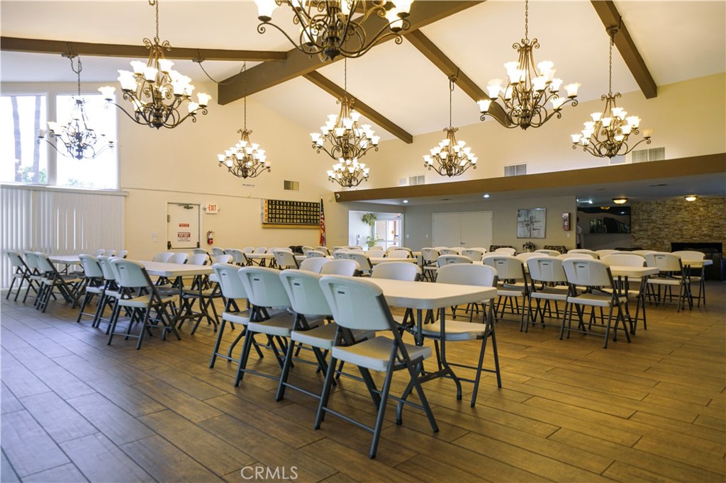 1919 West Coronet Avenue, Unit 190 Anaheim, CA 92801 - Photo 24 of 31 a view of a dining room with furniture a chandelier and wooden floor