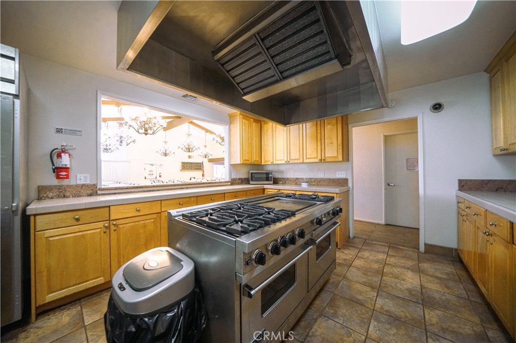 1919 West Coronet Avenue, Unit 190 Anaheim, CA 92801 - Photo 27 of 31 a kitchen with stainless steel appliances granite countertop a stove a sink and a refrigerator