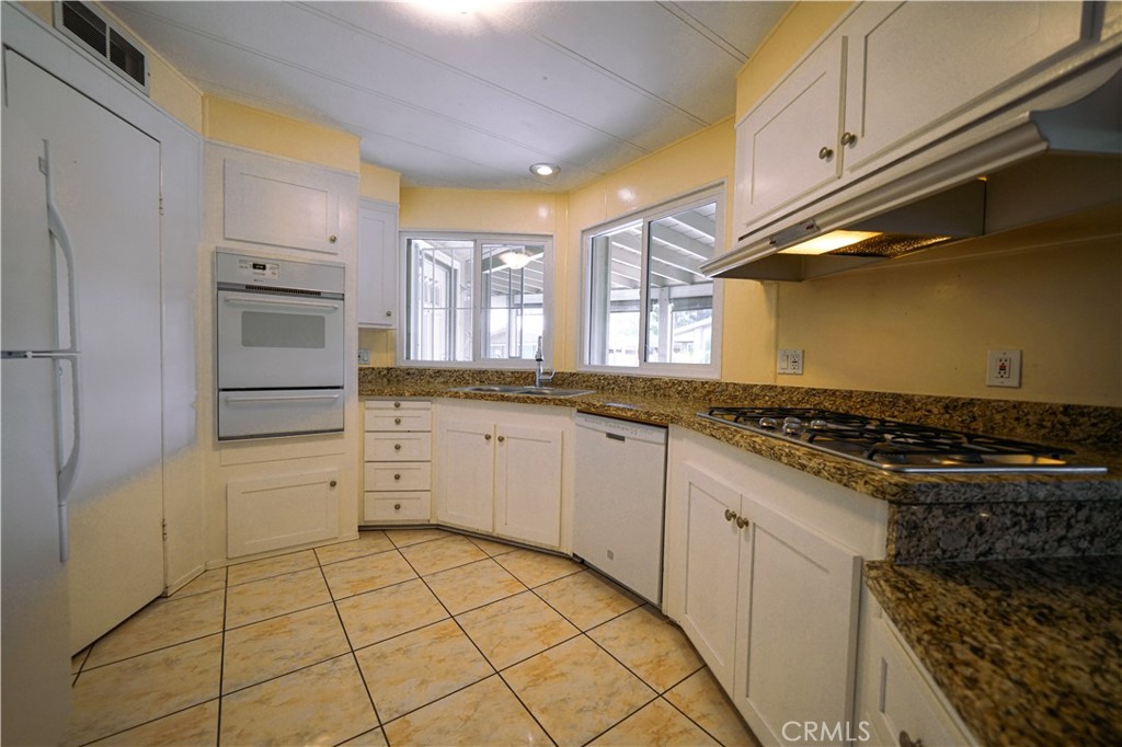 1919 West Coronet Avenue, Unit 190 Anaheim, CA 92801 - Photo 9 of 31 a kitchen with a stove and a refrigerator