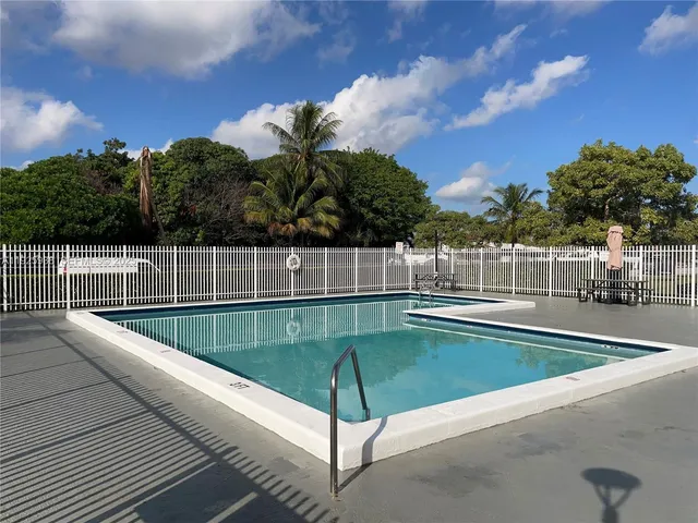 a view of a swimming pool with a lounge chairs