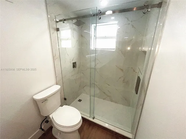 a bathroom with a shower and toilet