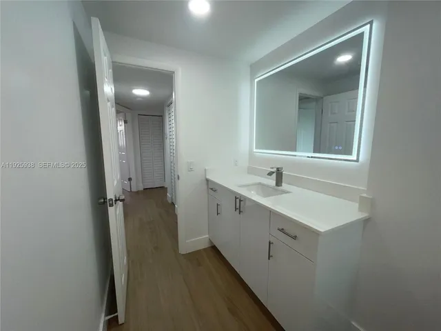 a spacious bathroom with a double vanity sink and mirror