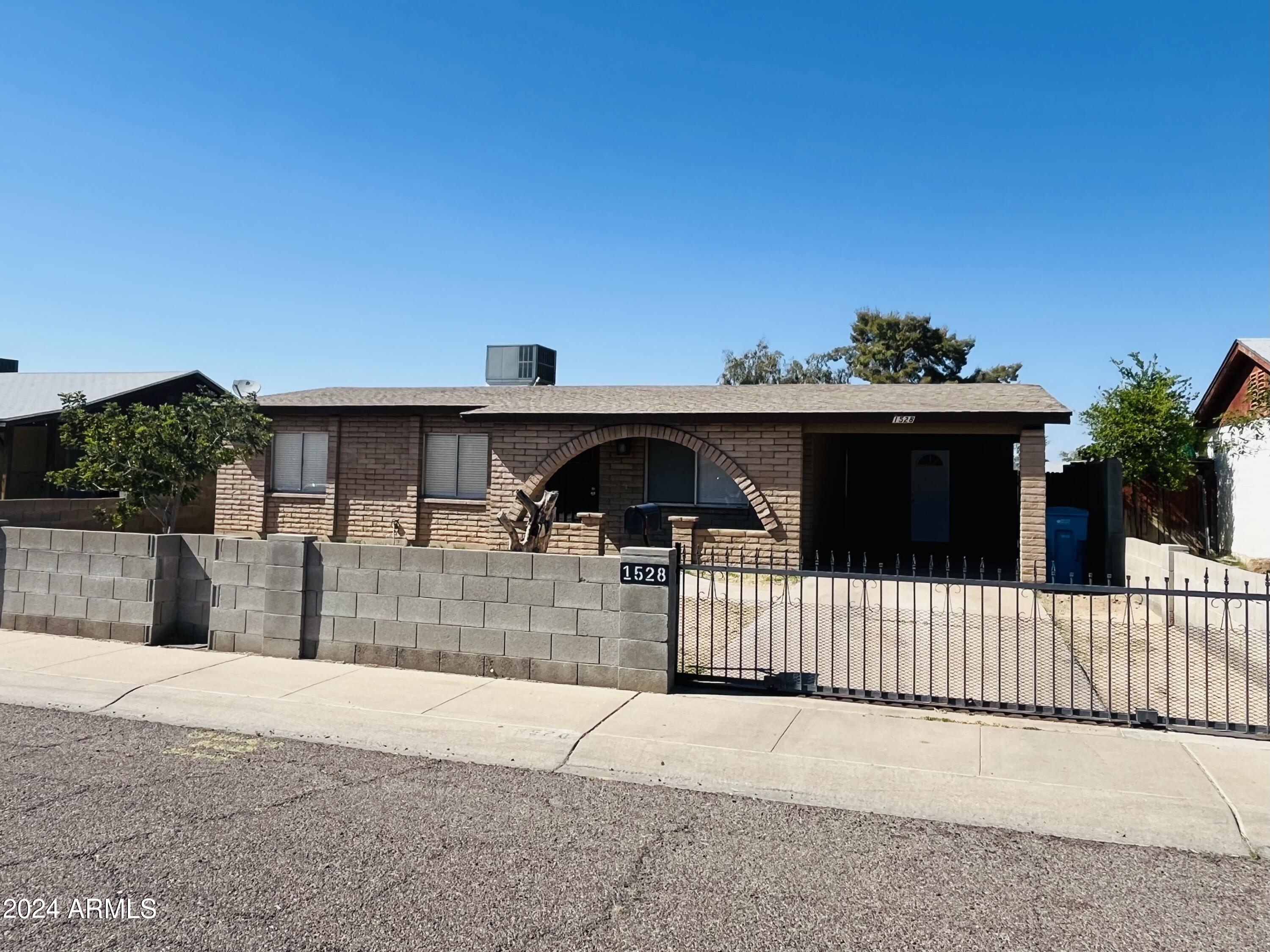 1528 West Maldonado Road Phoenix, AZ 85041 - Photo 1 of 19 a front view of a house with a yard