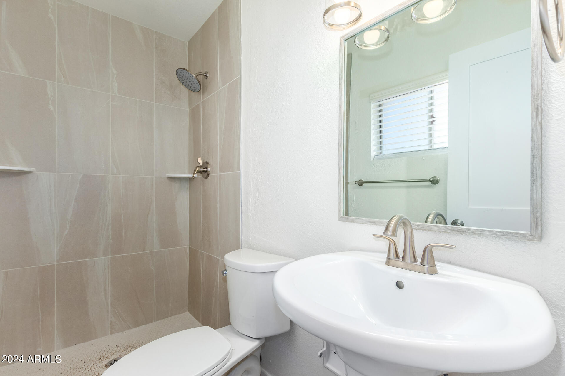 1528 West Maldonado Road Phoenix, AZ 85041 - Photo 16 of 19 a bathroom with a sink a toilet and shower