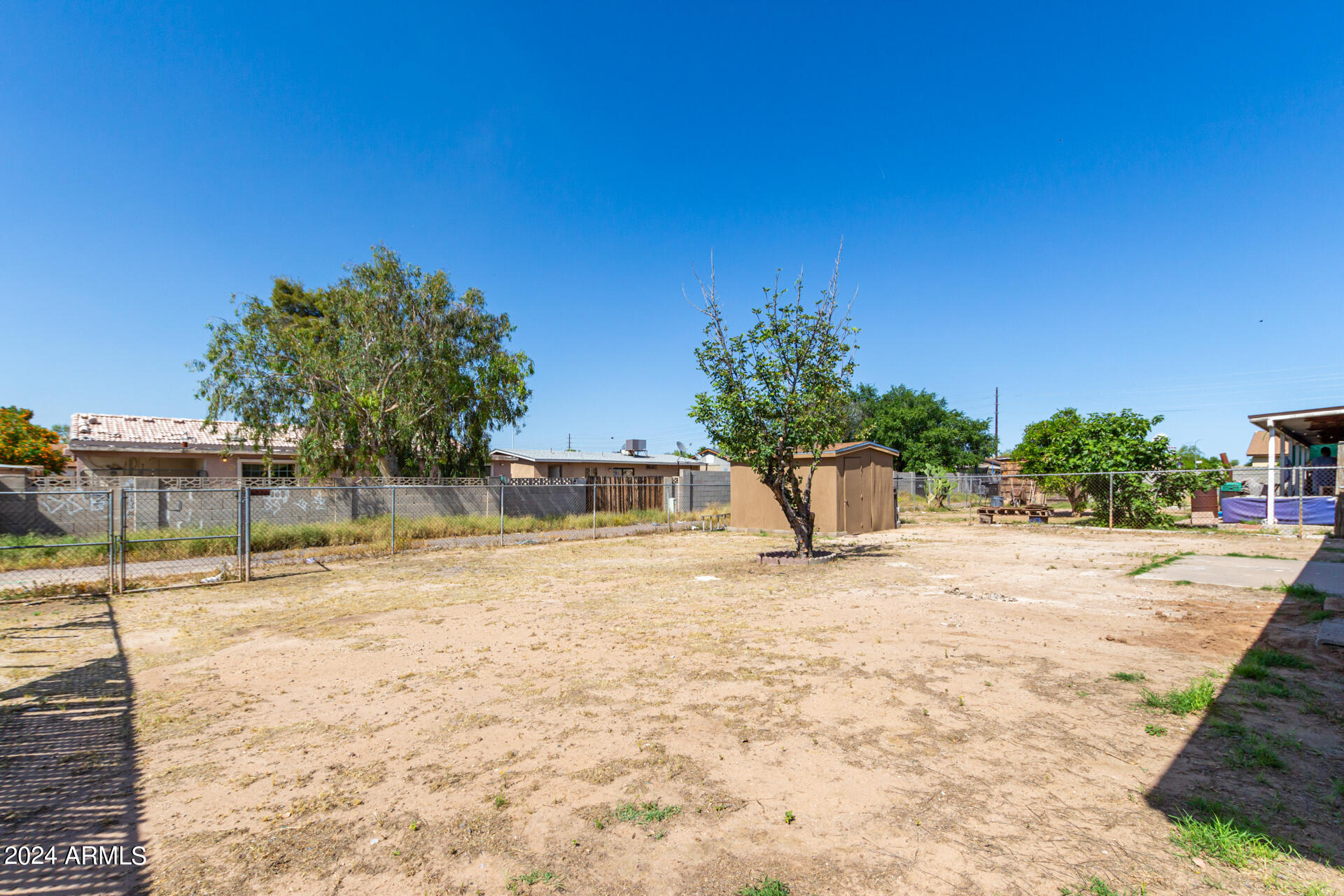 1528 West Maldonado Road Phoenix, AZ 85041 - Photo 18 of 19 a view of a house with a yard and garage