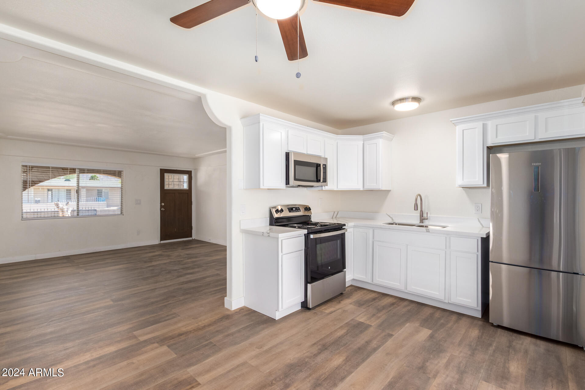 1528 West Maldonado Road Phoenix, AZ 85041 - Photo 8 of 19 a kitchen with granite countertop a refrigerator and a stove top oven
