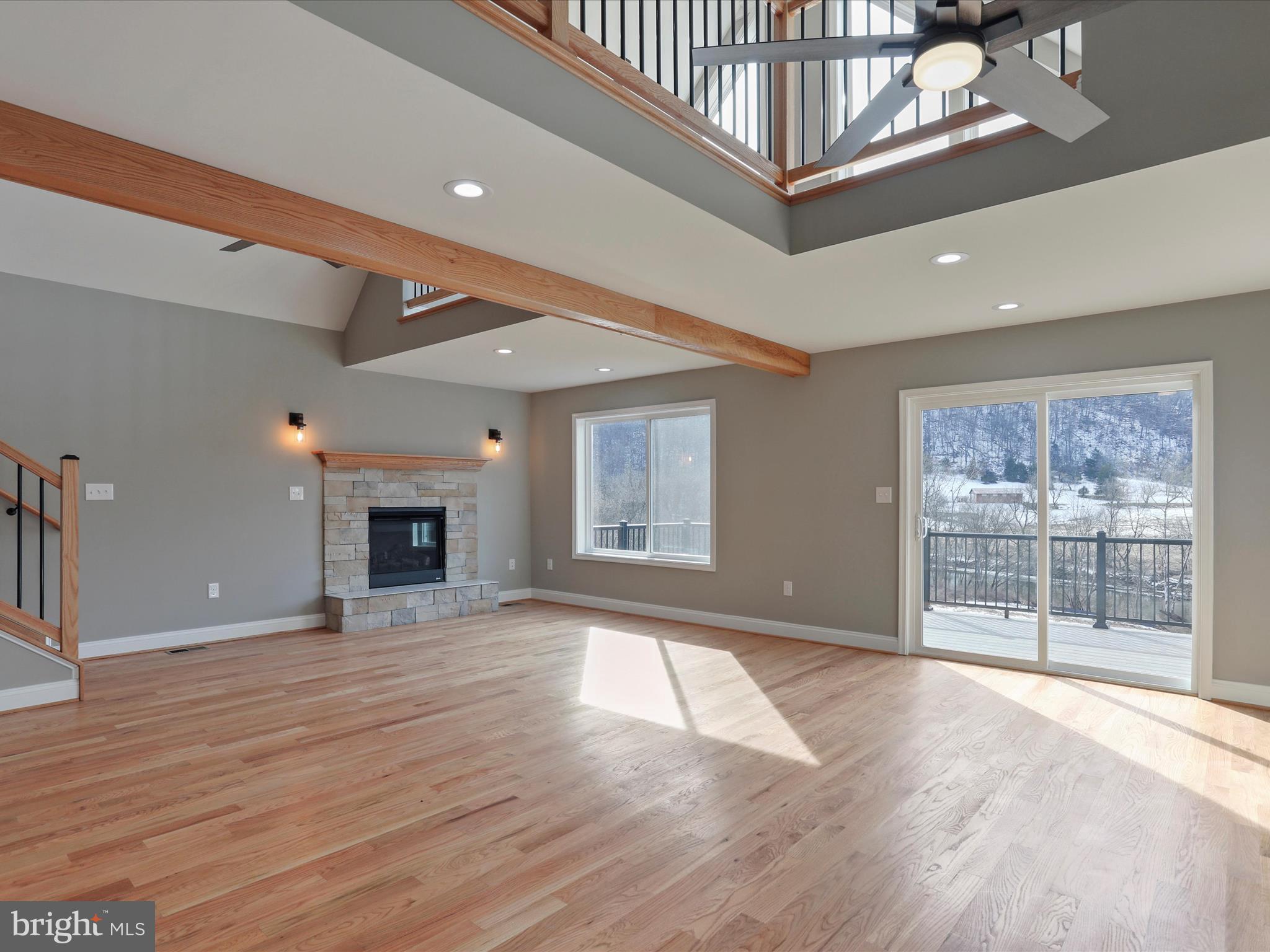628 Black Bear Road Maurertown, VA 22644 - Photo 43 of 67 a view of an empty room with wooden floor and a fireplace