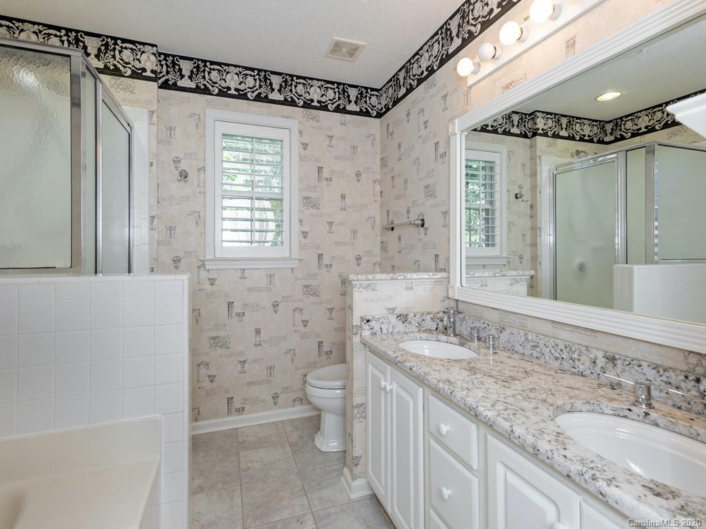 86 Stonehollow Road Fletcher, NC 28732 - Photo 15 of 23 a bathroom with a granite countertop sink toilet and shower