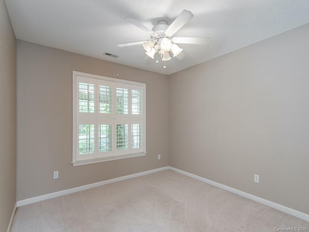 86 Stonehollow Road Fletcher, NC 28732 - Photo 19 of 23 an empty room with windows and chandelier fan