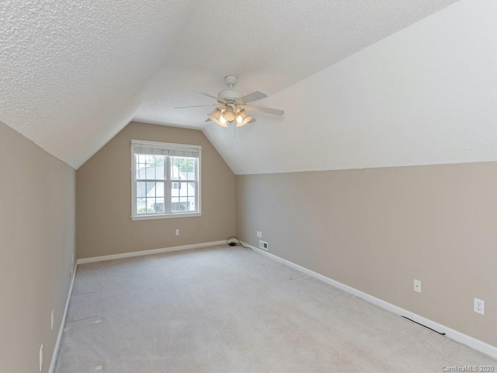 86 Stonehollow Road Fletcher, NC 28732 - Photo 21 of 23 an empty room with windows and chandelier fan