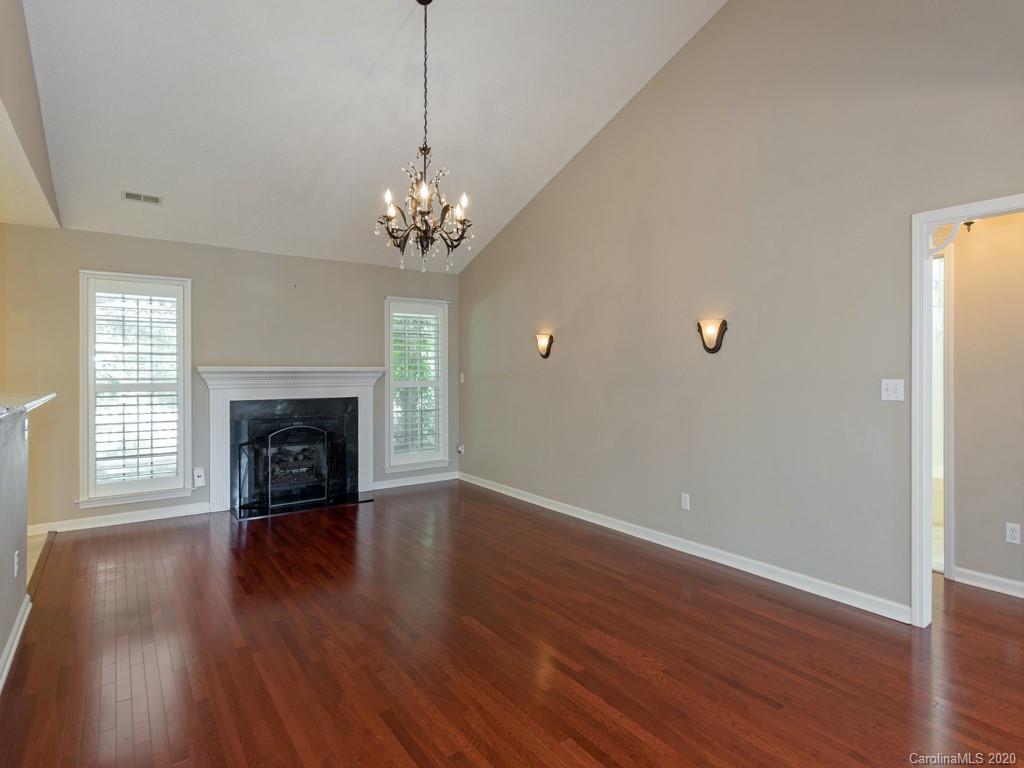 86 Stonehollow Road Fletcher, NC 28732 - Photo 5 of 23 a view of a livingroom with wooden floor a fireplace and windows