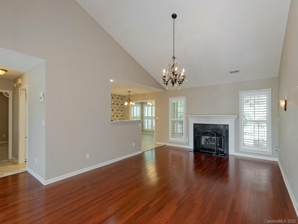 86 Stonehollow Road Fletcher, NC 28732 - Photo 7 of 23 a view of a livingroom with wooden floor a fireplace and windows