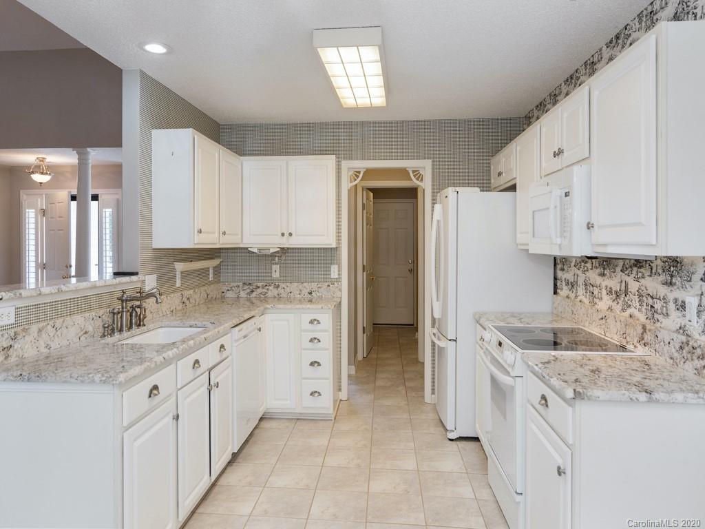 86 Stonehollow Road Fletcher, NC 28732 - Photo 8 of 23 a kitchen with granite countertop a sink stove and refrigerator