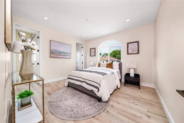a bedroom with a bed and wooden floor