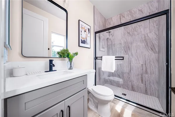 a bathroom with a sink a toilet and shower