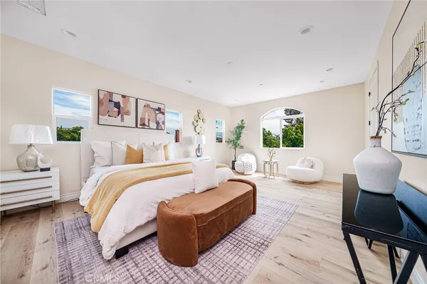 a bedroom with bed couch and window