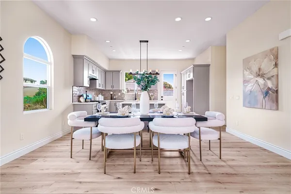 a view of a dining room with furniture window and wooden floor