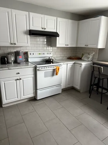 a kitchen with cabinets and white appliances