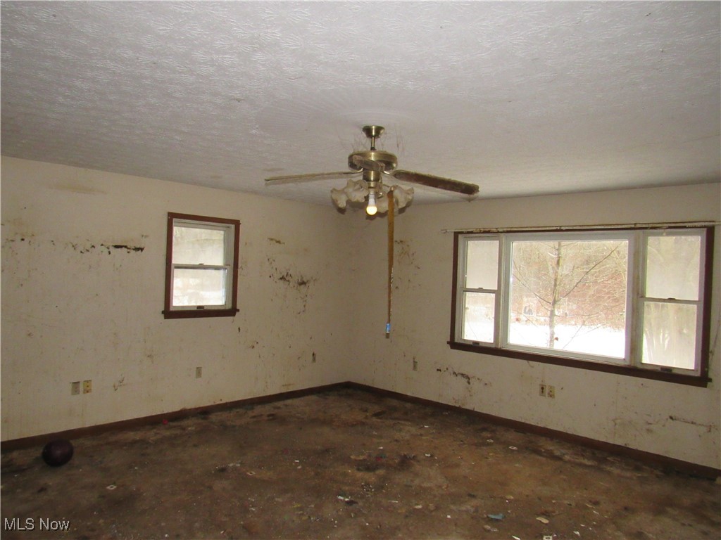 3813 Ranfield Road Kent, OH 44240 - Photo 10 of 24 Spare room featuring a textured ceiling and ceiling fan