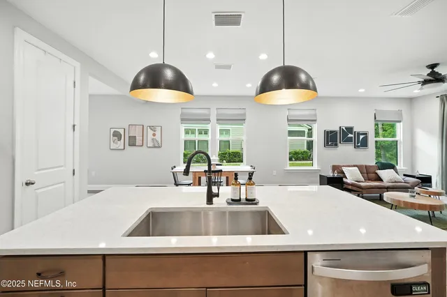 a view of a kitchen counter space a sink and cabinets