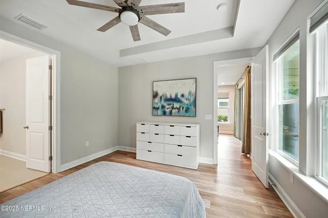 a bedroom with a bed and a painting on the wall