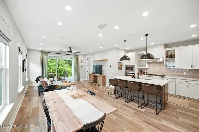 a large kitchen with a table and chairs in it
