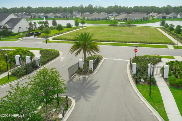 aerial view of a house with a big yard and large trees