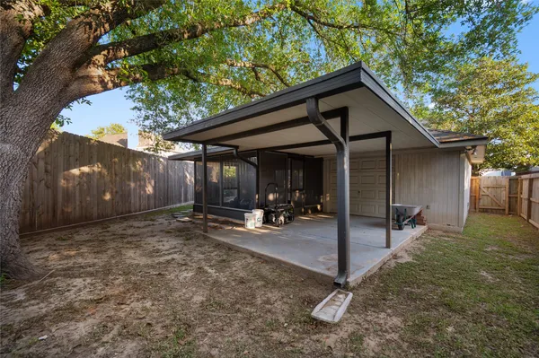 a view of a house with backyard and sitting area