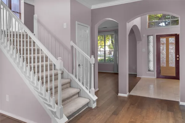 a view of entryway and hall with wooden floor